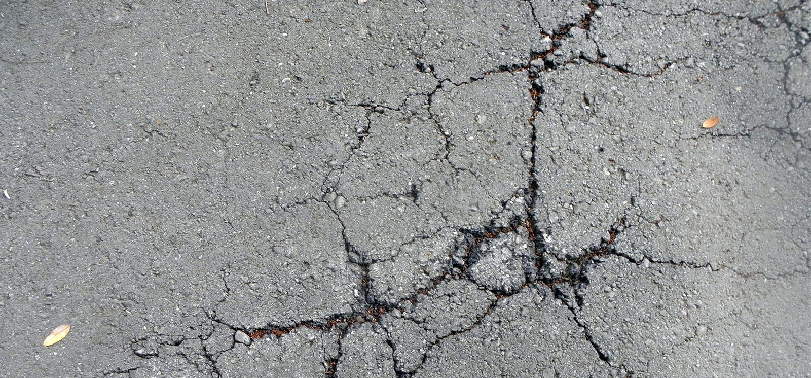 Asphalt pavement cracks. Cement pavement cracks